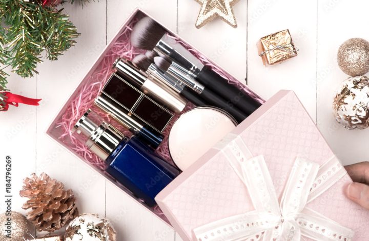 Flat lay of christmas ball, gift and cosmetic. Holiday Background. Beauty concept.