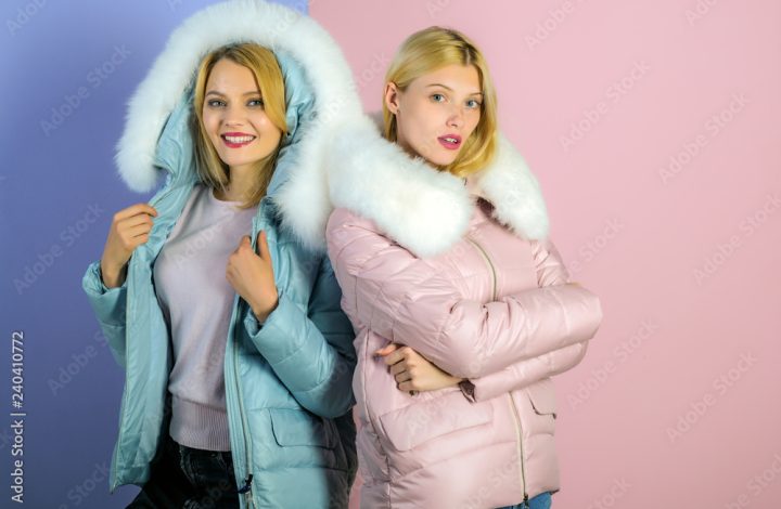 For a weather appropriate winter look. Pretty women in fashionable puffers. Sexy women wear warm winter coats. Fashion models in hoods with fur. Winter fashion trends. Keeps warm and looks good
